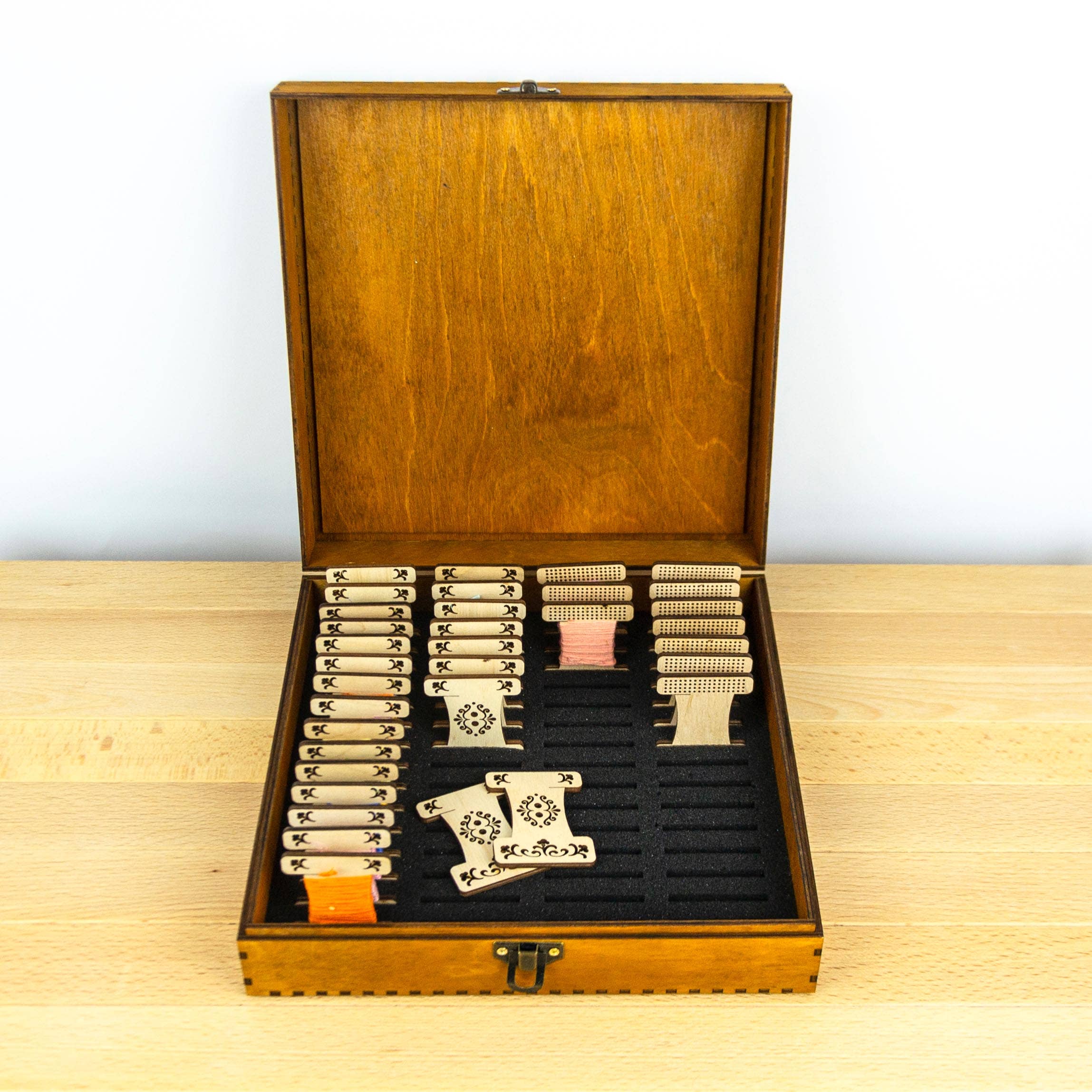 Engraved wooden box for embroidery bobbins